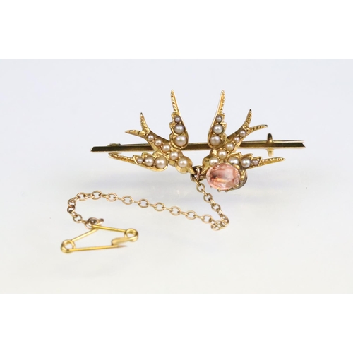 99 - Early 20th century seed pearl yellow metal brooch, modelled as two swallows, foiled rock crystal dro... 