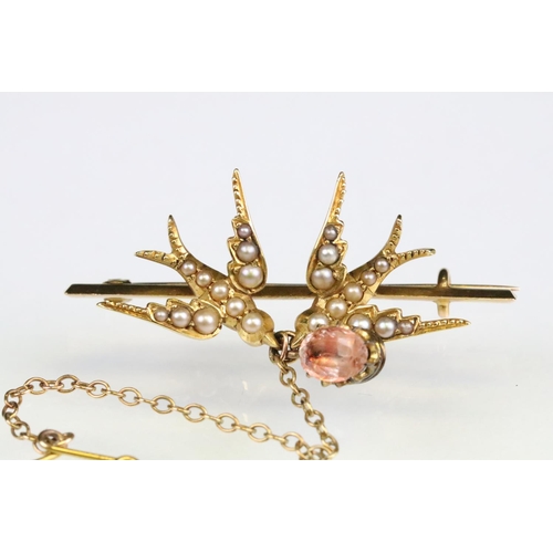 99 - Early 20th century seed pearl yellow metal brooch, modelled as two swallows, foiled rock crystal dro... 