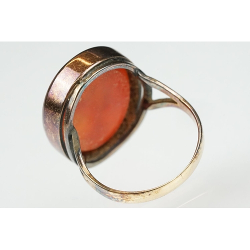 104 - Carnelian intaglio gilt metal ring, the oval carnelian intaglio depicting Roman head facing left, di... 