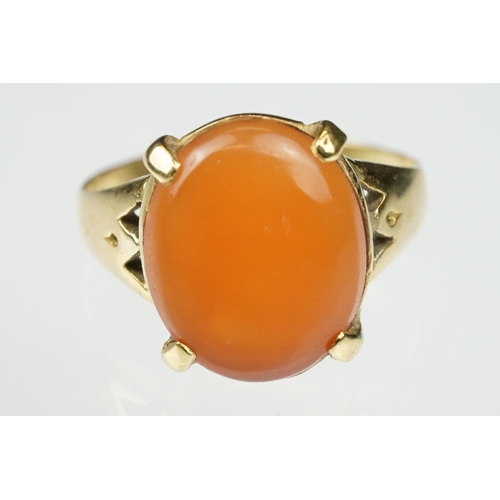 106 - Carnelian unmarked yellow gold ring, the oval cabochon cut carnelian measuring approx 13 x 10.5mm, c... 