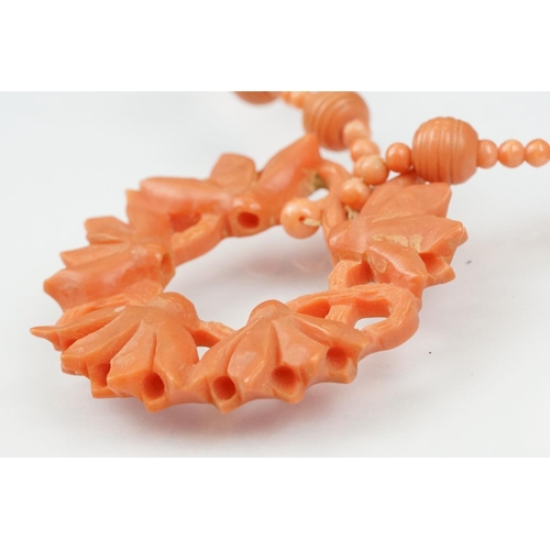 107 - Early 20th century coral 9ct gold necklace, the principal carved coral disc depicting lotus flowers,... 