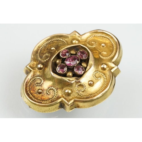 108 - Early Victorian garnet yellow metal brooch of quatrefoil form, five garnets, foil backed, rope twist... 