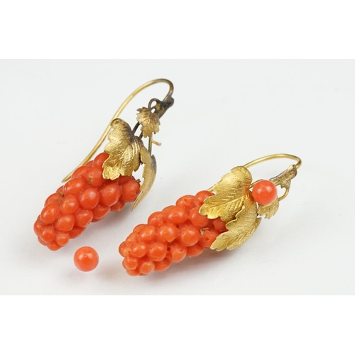 23 - Pair of 19th century carved coral yellow metal earrings, the coral carved as grapes, cast vine leave... 