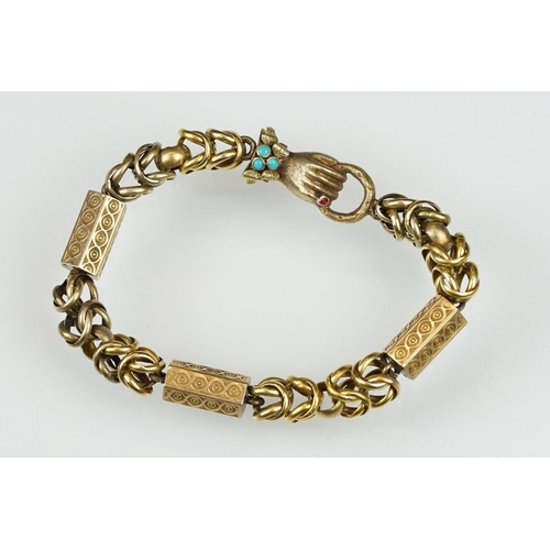 25 - 19th century garnet and turquoise yellow metal bracelet, the clasp modelled as a hand holding a coil... 