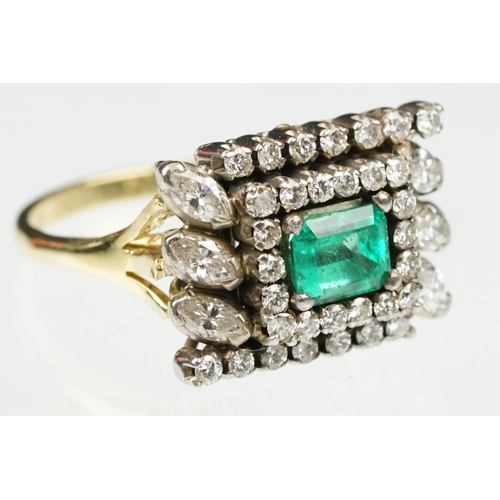 29 - Emerald and diamond 18ct yellow and white gold cluster ring, the central emerald cut emerald measuri... 