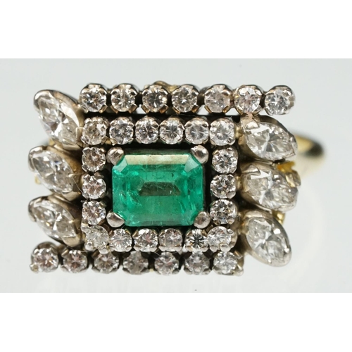 29 - Emerald and diamond 18ct yellow and white gold cluster ring, the central emerald cut emerald measuri... 