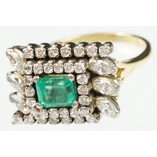 29 - Emerald and diamond 18ct yellow and white gold cluster ring, the central emerald cut emerald measuri... 