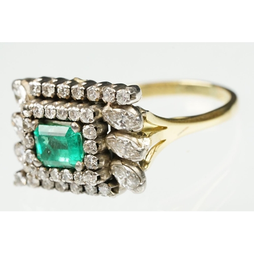 29 - Emerald and diamond 18ct yellow and white gold cluster ring, the central emerald cut emerald measuri... 