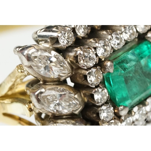 29 - Emerald and diamond 18ct yellow and white gold cluster ring, the central emerald cut emerald measuri... 