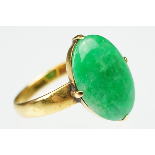 9 - Imperial jade yellow gold ring, the oval cabochon cut jade measuring approx 14.5 x 10.5mm, claw set,... 