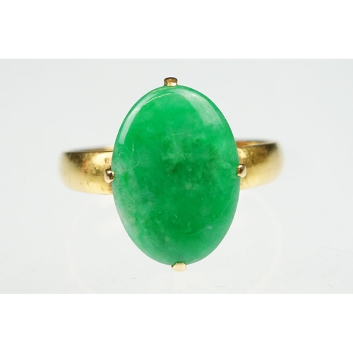 9 - Imperial jade yellow gold ring, the oval cabochon cut jade measuring approx 14.5 x 10.5mm, claw set,... 