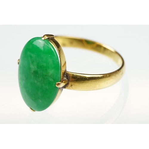 9 - Imperial jade yellow gold ring, the oval cabochon cut jade measuring approx 14.5 x 10.5mm, claw set,... 