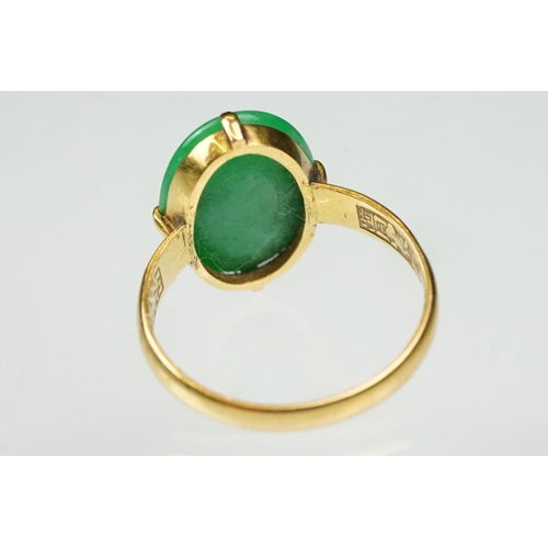 9 - Imperial jade yellow gold ring, the oval cabochon cut jade measuring approx 14.5 x 10.5mm, claw set,... 