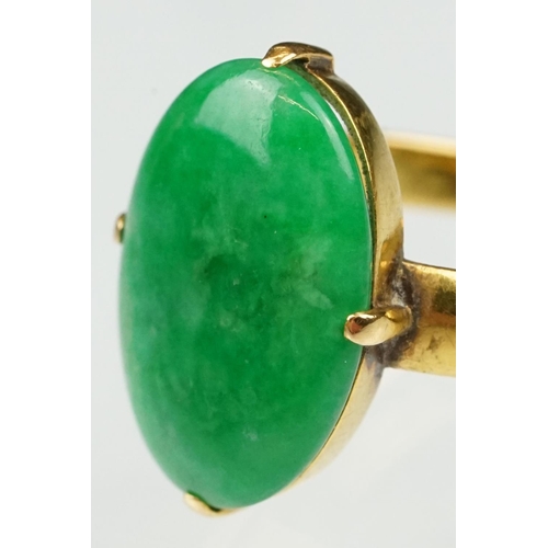 9 - Imperial jade yellow gold ring, the oval cabochon cut jade measuring approx 14.5 x 10.5mm, claw set,... 