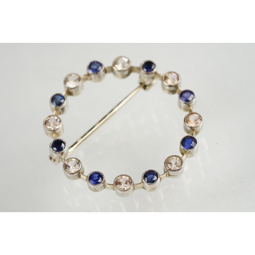 112 - Sapphire and colourless quartz white metal wreath brooch, alternate set, rubover settings with mille... 