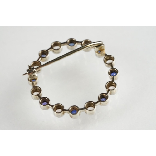 112 - Sapphire and colourless quartz white metal wreath brooch, alternate set, rubover settings with mille... 