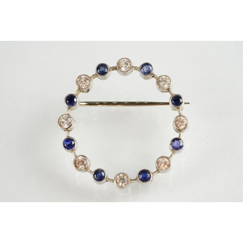 112 - Sapphire and colourless quartz white metal wreath brooch, alternate set, rubover settings with mille... 