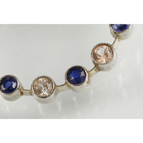 112 - Sapphire and colourless quartz white metal wreath brooch, alternate set, rubover settings with mille... 