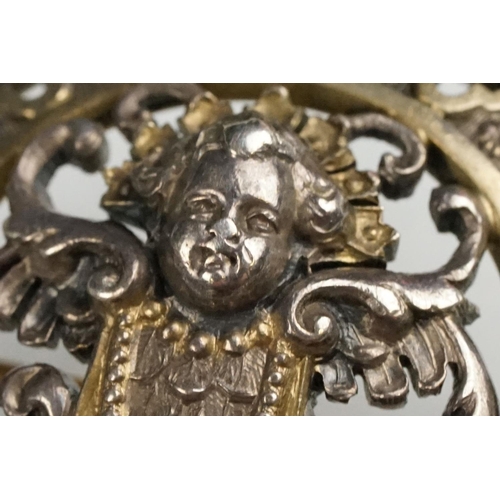 114 - Indian seed pearl and garnet unmarked parcel gilt silver brooch, the centre depicting cast cherub fa... 