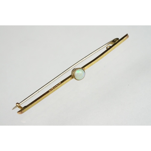 122 - Precious white opal 9ct gold bar brooch, the round cabochon cut opal displaying indigo, yellow, gree... 