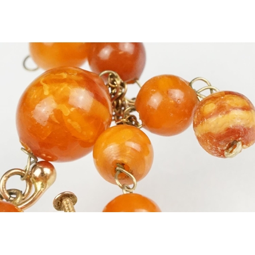 128 - Pair of amber-style 9ct yellow gold screw back drop earrings; a pair of yellow Bakelite style clip-o... 