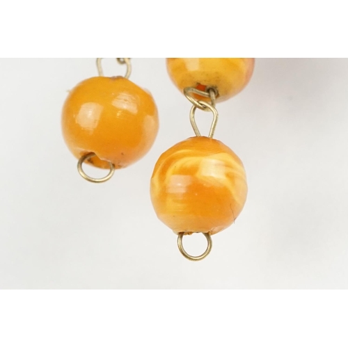 128 - Pair of amber-style 9ct yellow gold screw back drop earrings; a pair of yellow Bakelite style clip-o... 