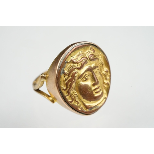 53 - Cameo ring, the gilt metal cast panel depicting a head, rubover yellow metal settings and shank, V s... 