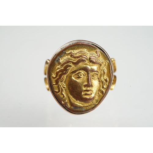 53 - Cameo ring, the gilt metal cast panel depicting a head, rubover yellow metal settings and shank, V s... 