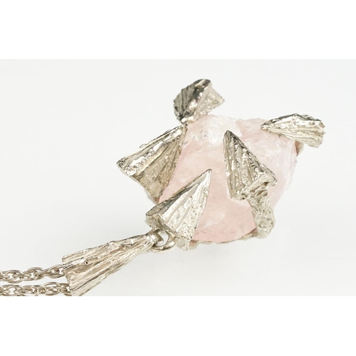 54 - Brutalist rose quartz unmarked silver pendant necklace, the rough rose quart with abstract triangula... 