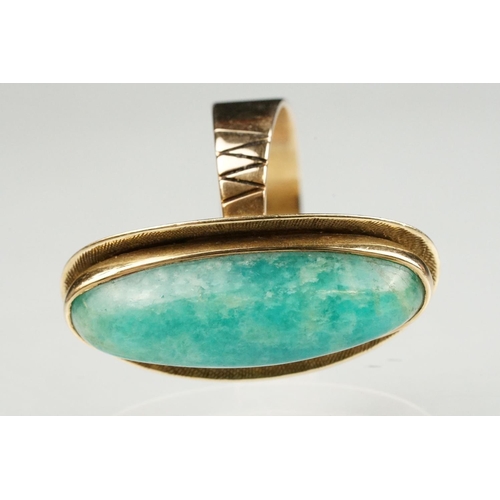 55 - Green hardstone 9ct yellow gold ring, the elongated oval cabochon possibly aventurine quartz, rubove... 