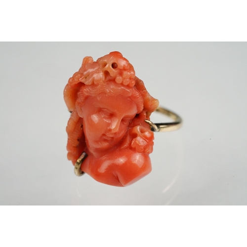 60 - 19th century coral 9ct yellow gold ring, the carved coral depicting a female head with grapes and vi... 