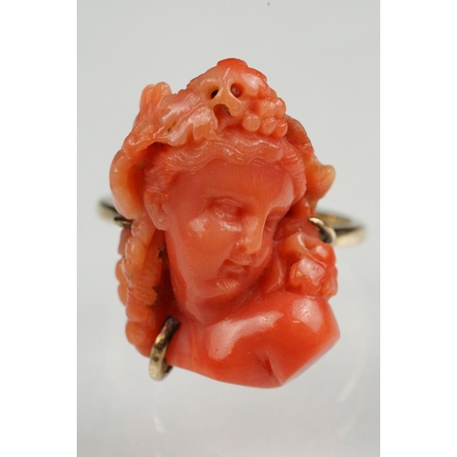 60 - 19th century coral 9ct yellow gold ring, the carved coral depicting a female head with grapes and vi... 