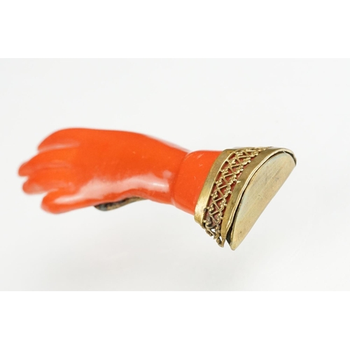 61 - 19th century coral gilt metal brooch, modelled as a cuffed hand, hinged pin and simple loop brooch f... 