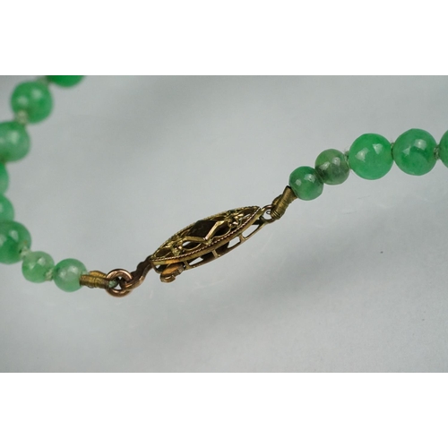 62 - Jade 9ct yellow gold bead necklace, seventy-seven graduated circular beads, the largest diameter app... 