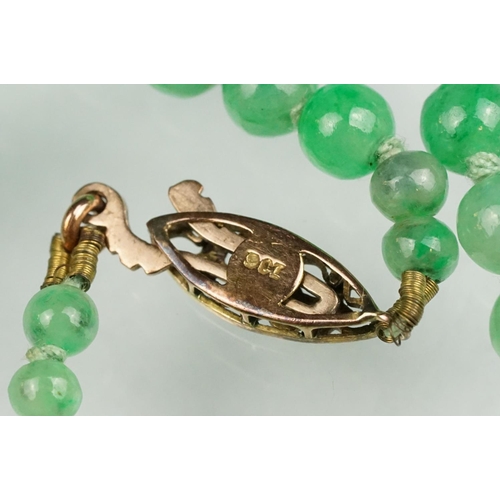 62 - Jade 9ct yellow gold bead necklace, seventy-seven graduated circular beads, the largest diameter app... 