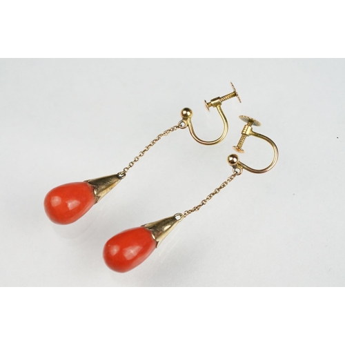 65 - Pair of early 20th century coral 9ct yellow gold drop earrings, the tapered coral with conical yello... 