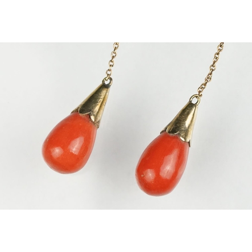 65 - Pair of early 20th century coral 9ct yellow gold drop earrings, the tapered coral with conical yello... 