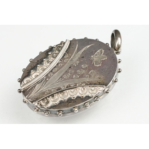 68 - 19th century style white metal oval locket, engraved lily of the valley and butterfly decoration, ap... 