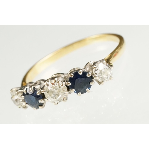 73 - Sapphire and diamond yellow and white metal set five stone ring, three graduated old round cut diamo... 