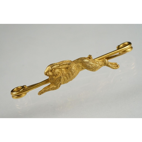 77 - Early 20th century yellow metal bar brooch modelled as a leaping hare, safety-pin style brooch fitti... 