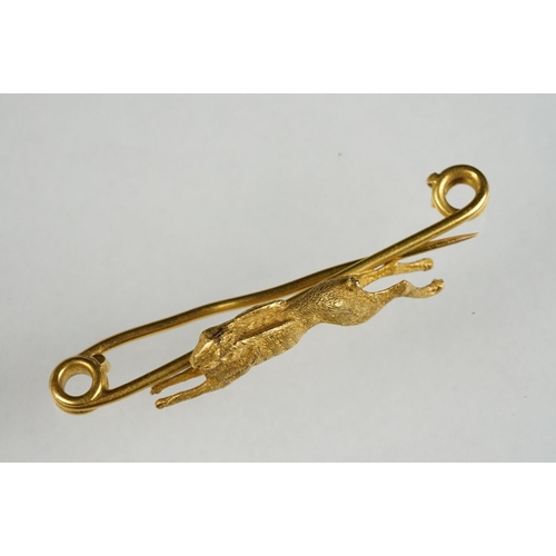 77 - Early 20th century yellow metal bar brooch modelled as a leaping hare, safety-pin style brooch fitti... 