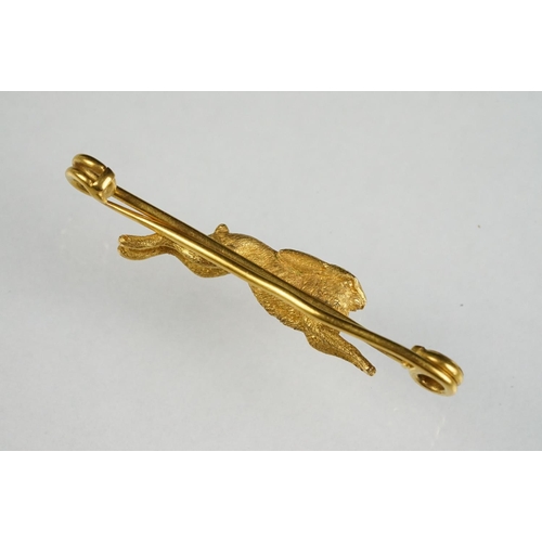 77 - Early 20th century yellow metal bar brooch modelled as a leaping hare, safety-pin style brooch fitti... 