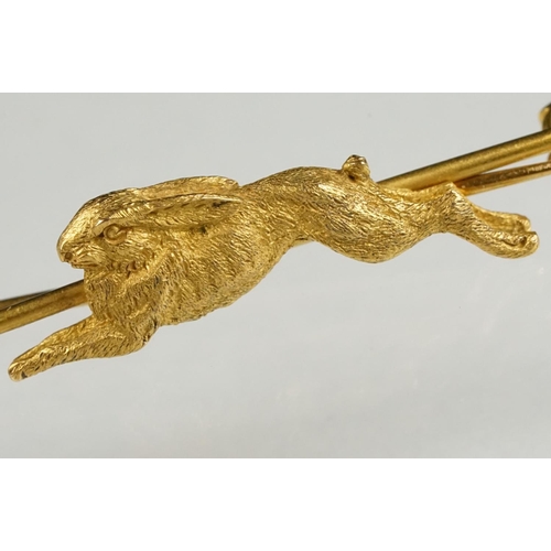 77 - Early 20th century yellow metal bar brooch modelled as a leaping hare, safety-pin style brooch fitti... 