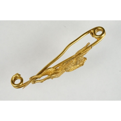 77 - Early 20th century yellow metal bar brooch modelled as a leaping hare, safety-pin style brooch fitti... 