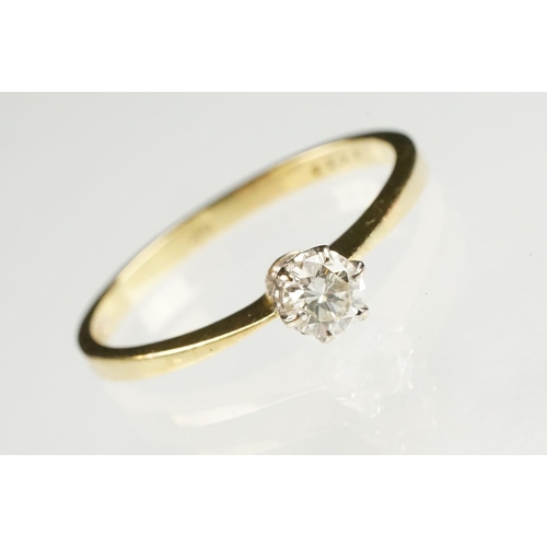 79 - Diamond solitaire 18ct yellow and white gold set ring, the round brilliant cut diamond stated weight... 