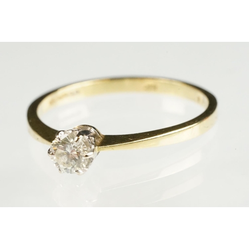 79 - Diamond solitaire 18ct yellow and white gold set ring, the round brilliant cut diamond stated weight... 