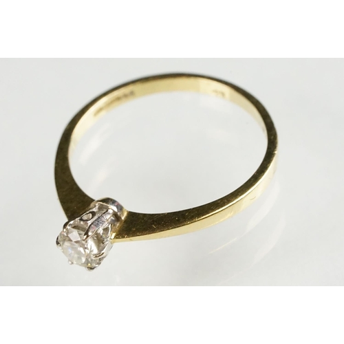 79 - Diamond solitaire 18ct yellow and white gold set ring, the round brilliant cut diamond stated weight... 