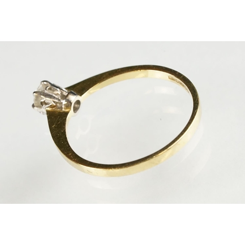 79 - Diamond solitaire 18ct yellow and white gold set ring, the round brilliant cut diamond stated weight... 