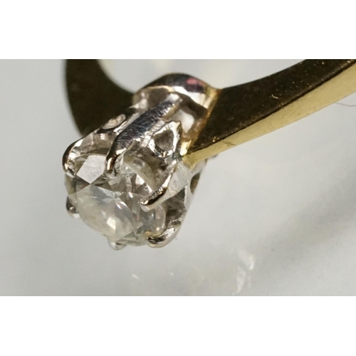 79 - Diamond solitaire 18ct yellow and white gold set ring, the round brilliant cut diamond stated weight... 