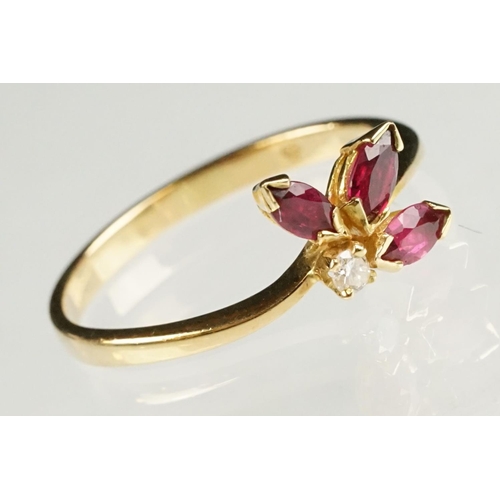 80 - Ruby and diamond 18ct yellow gold ring, three marquise cut rubies, claw set, the principal ruby meas... 